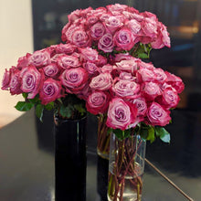 3 vases full of bouquets of Magenta and Lavender Bi-Colored roses
